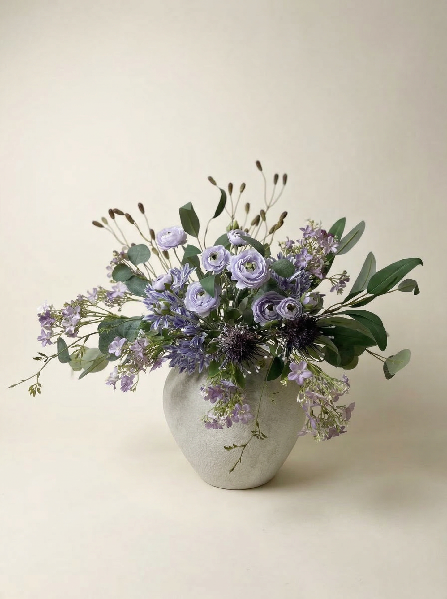 Vase with a bouquet of flowers on a beige background
