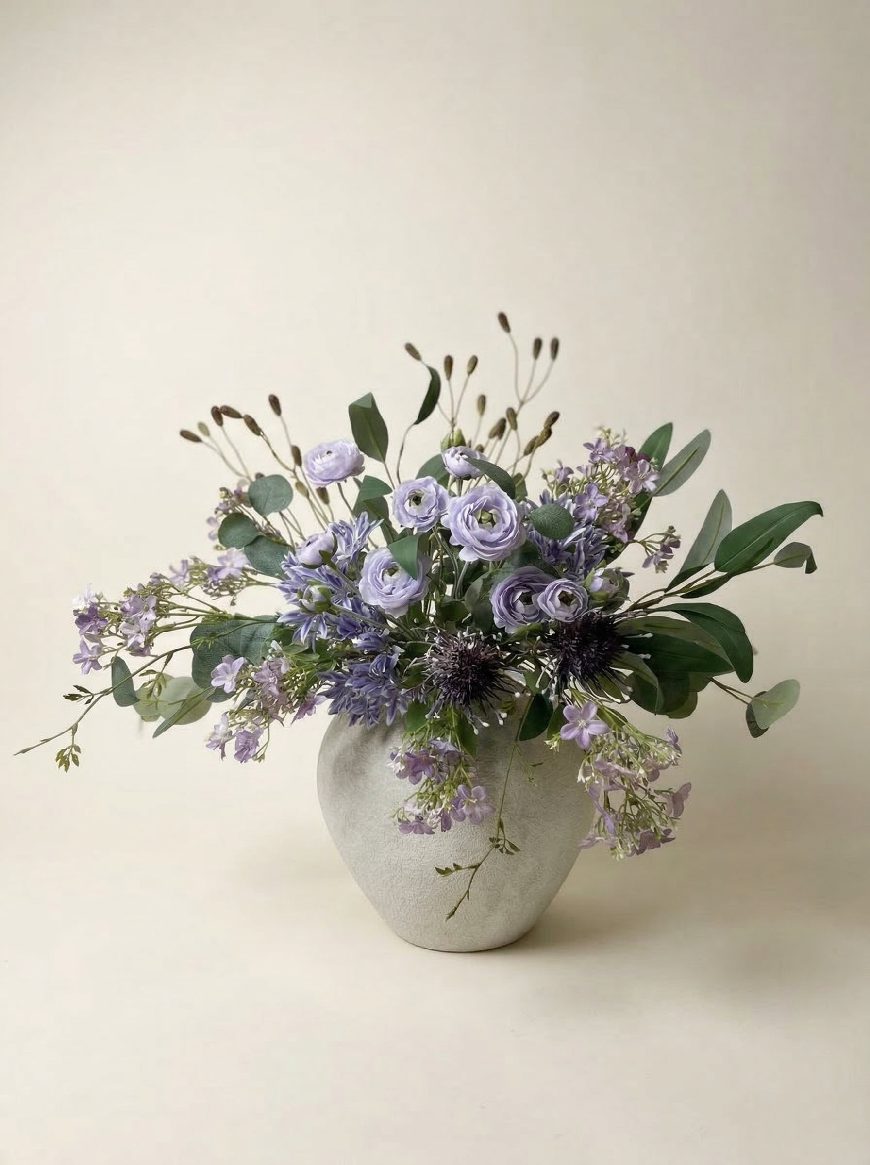 Vase with a bouquet of flowers on a beige background